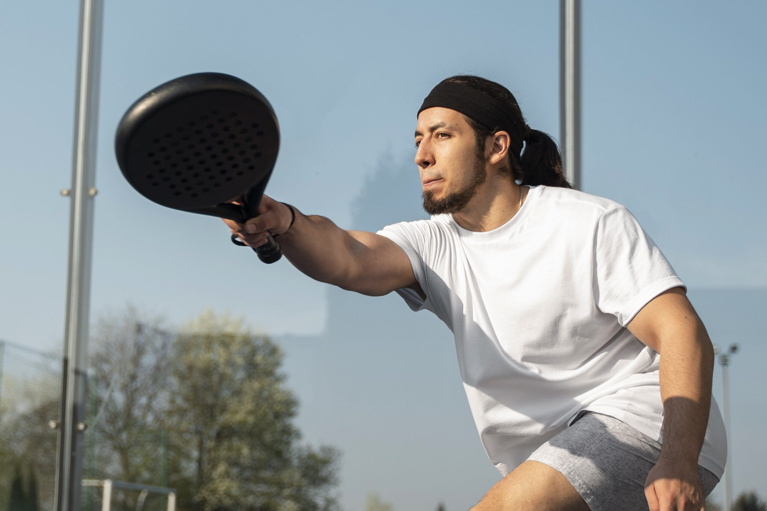 low-angle-man-playing-paddle-tennis